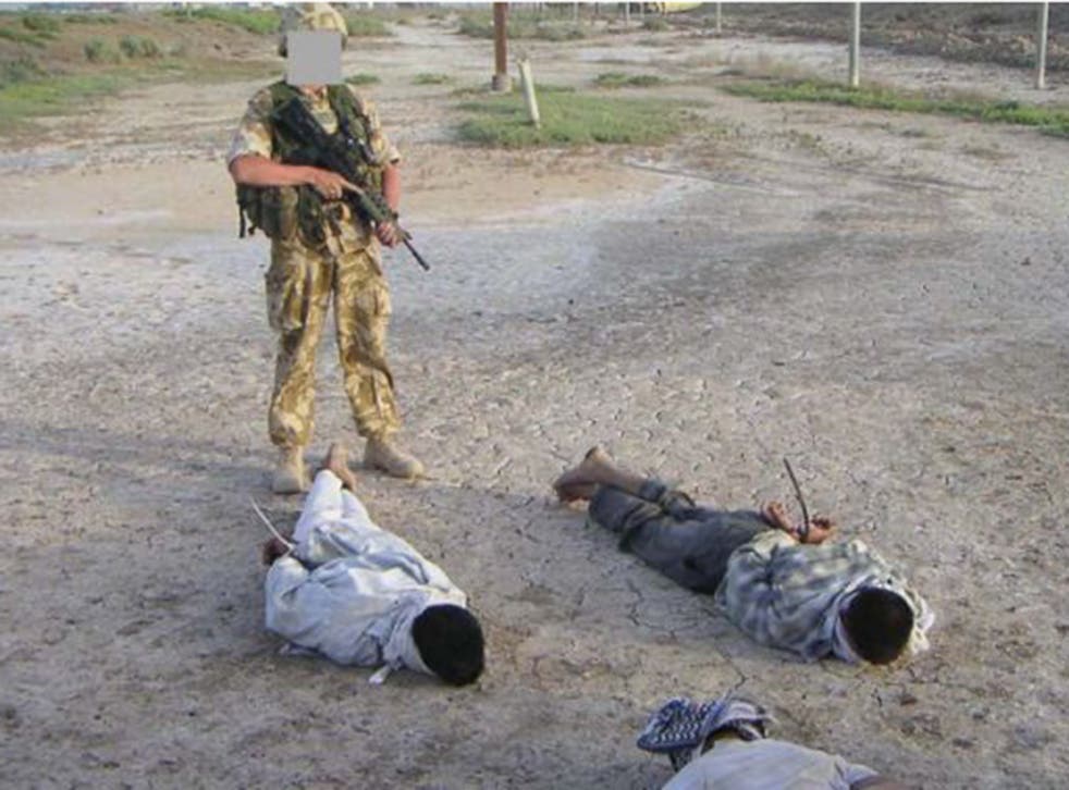 Detained Iraqis being guarded by a British soldier that was shown at the The Al-Sweady Inquiry. The long-running inquiry into claims that British troops killed and tortured Iraqi civilians a decade ago will deliver its final report
