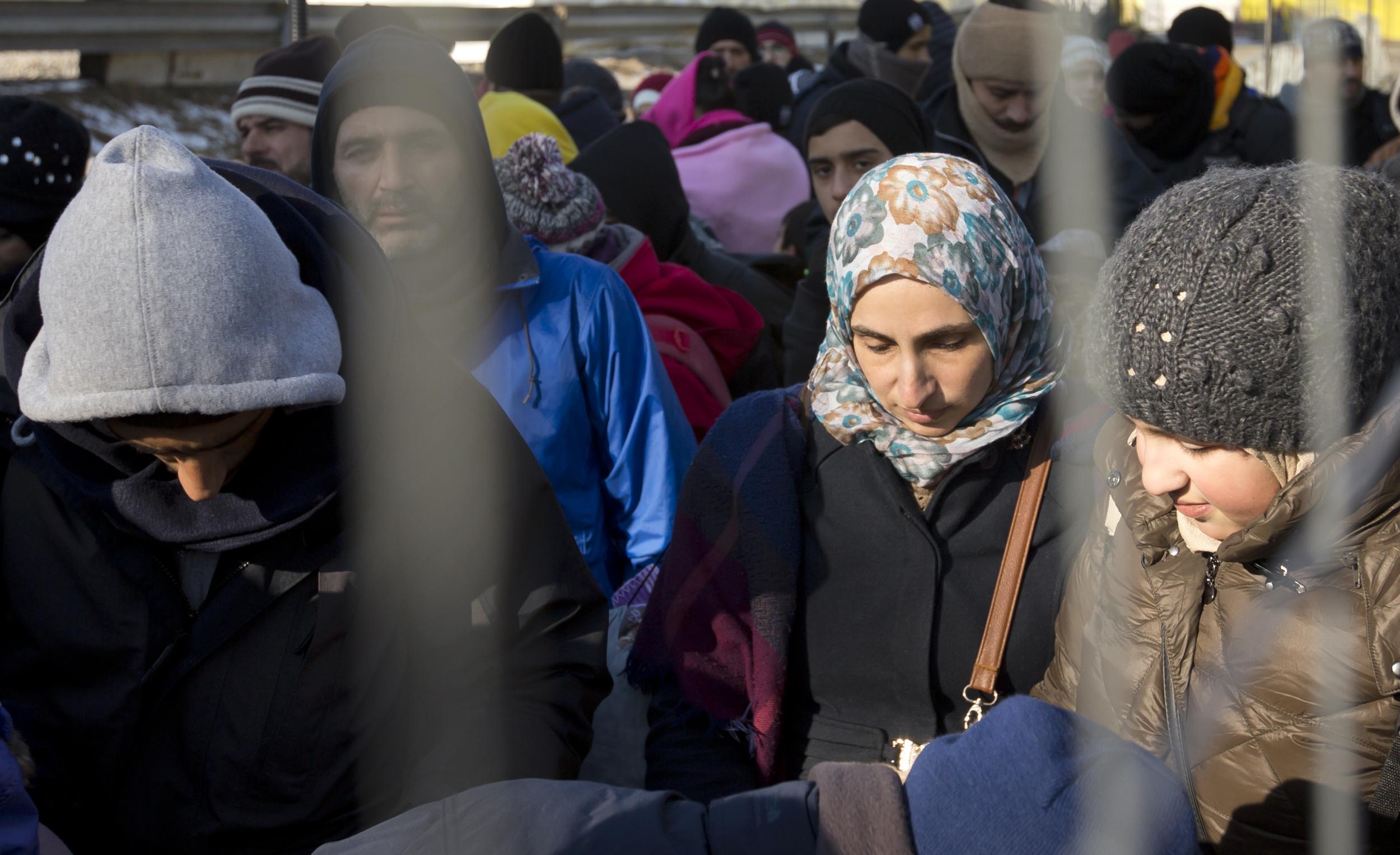 Migrants wait to be allowed to cross the border from Slovenia, in Spielfeld, Austria