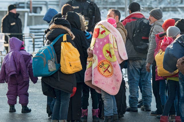 Refugees walk to a special train to Duesseldorf at the train station in Passau, Germany, 16 January 2016