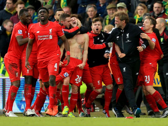 Jurgen Klopp celebrates with his Liverpool players after Adam Lallana's late winner against Norwich