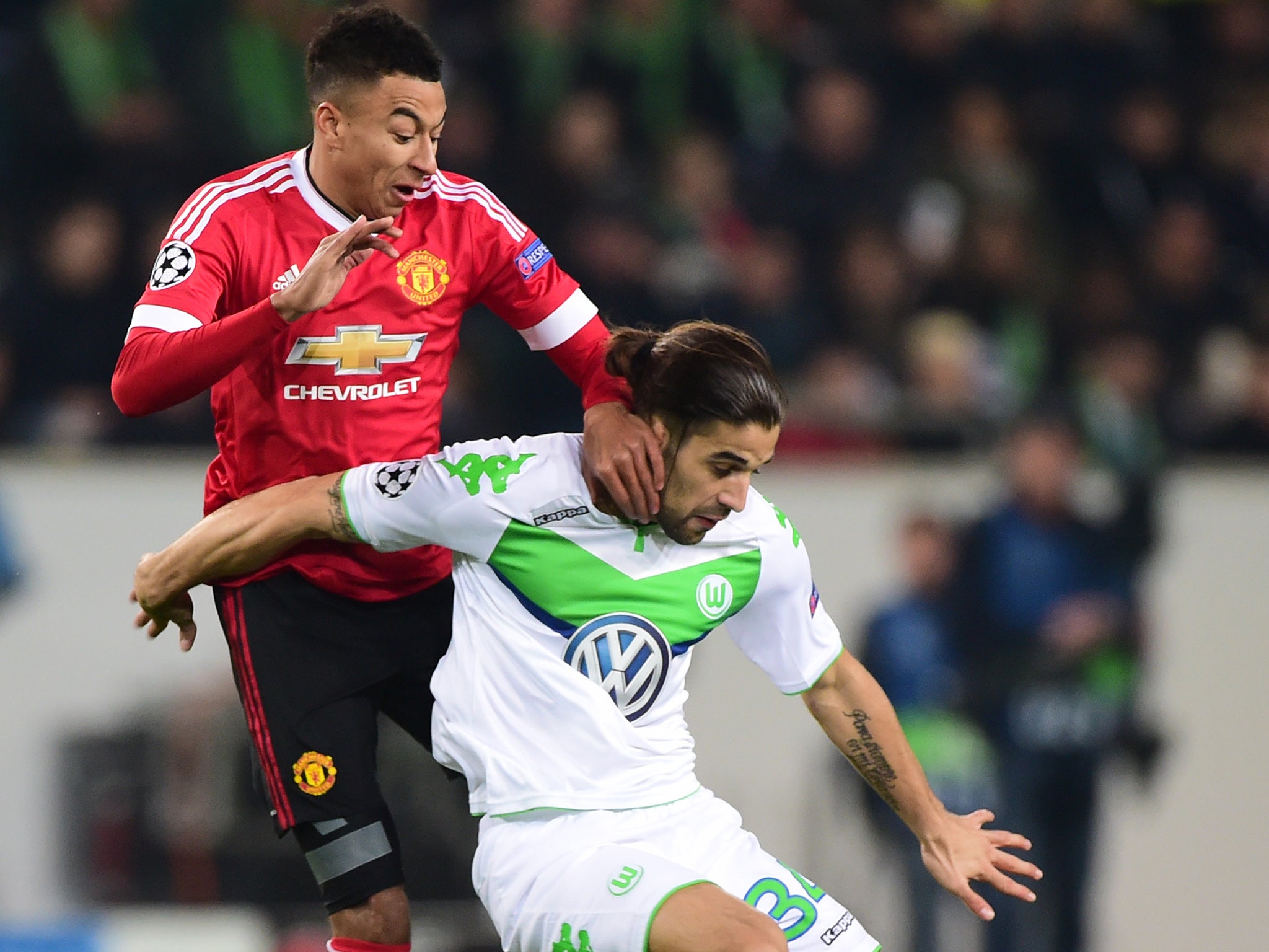 Wolfsburg's Ricardo Rodriguez holds off Manchester United's Jesse Lingard