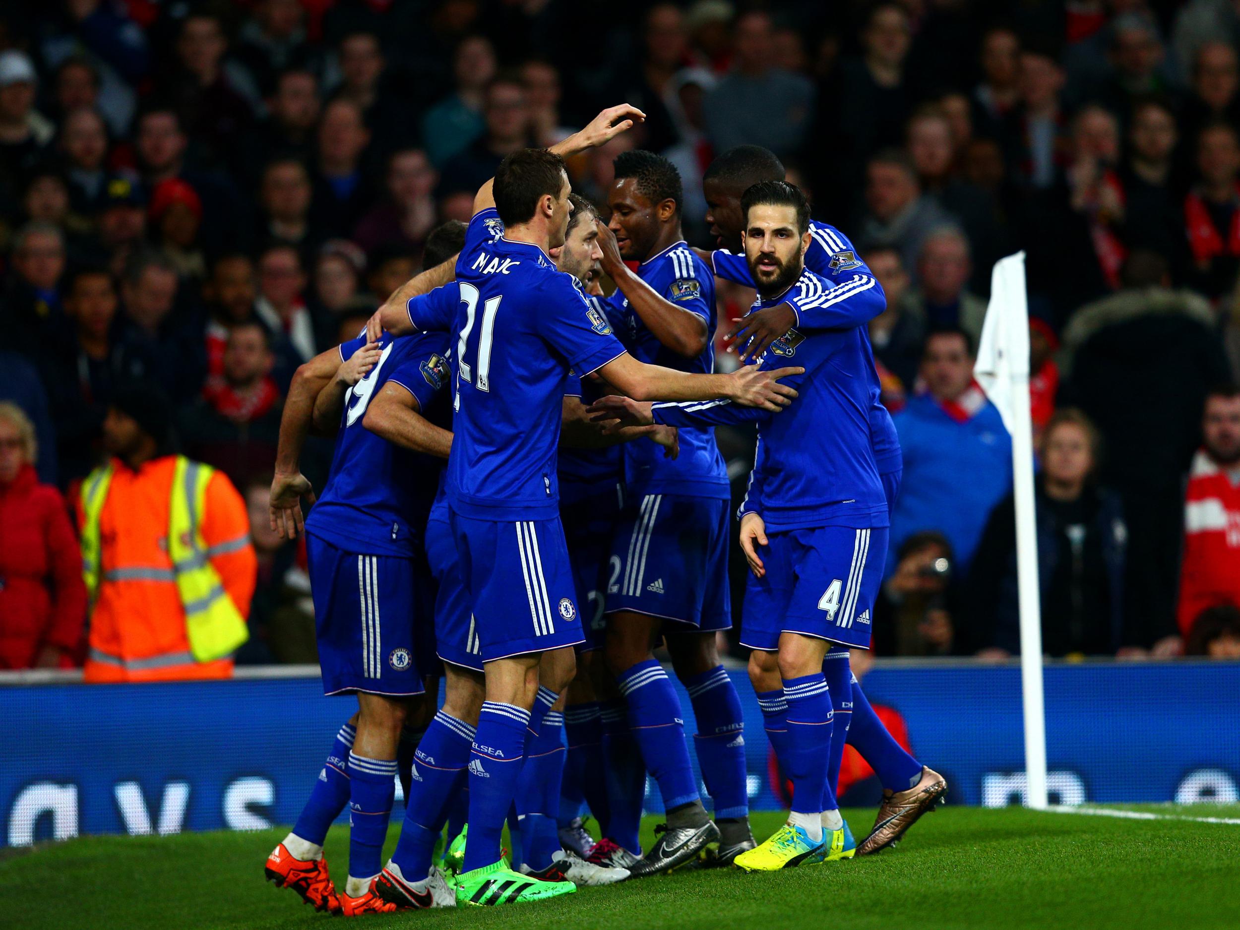 Diego Costa is mobbed by his Chelsea team-mates after scoring the opener against Arsenal