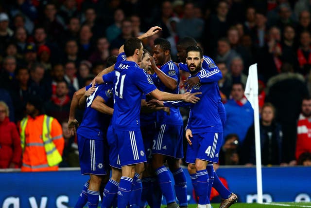 Diego Costa is mobbed by his Chelsea team-mates after scoring the opener against Arsenal