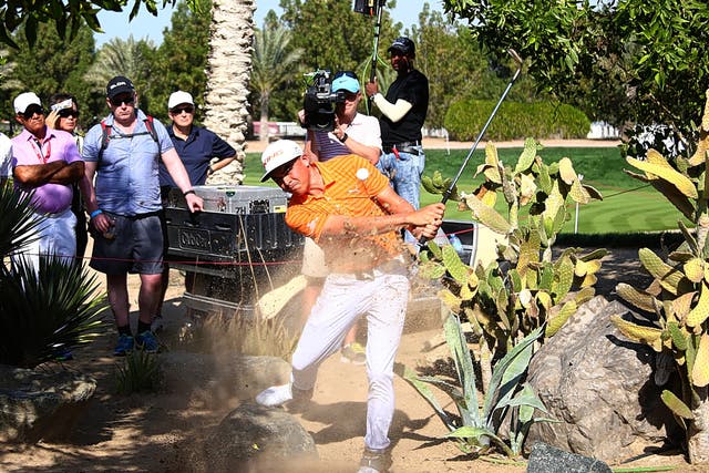 Rickie Fowler hits out of trouble on the seventh hole on his way to victory in the Abu Dhabi HSBC Championship yesterday