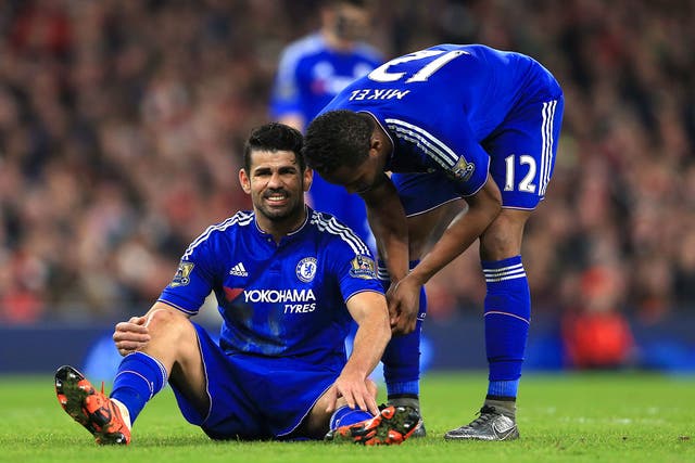 Diego Costa on the floor injured, talking to John Obi-Mikel, shortly before the Spain striker was substituted