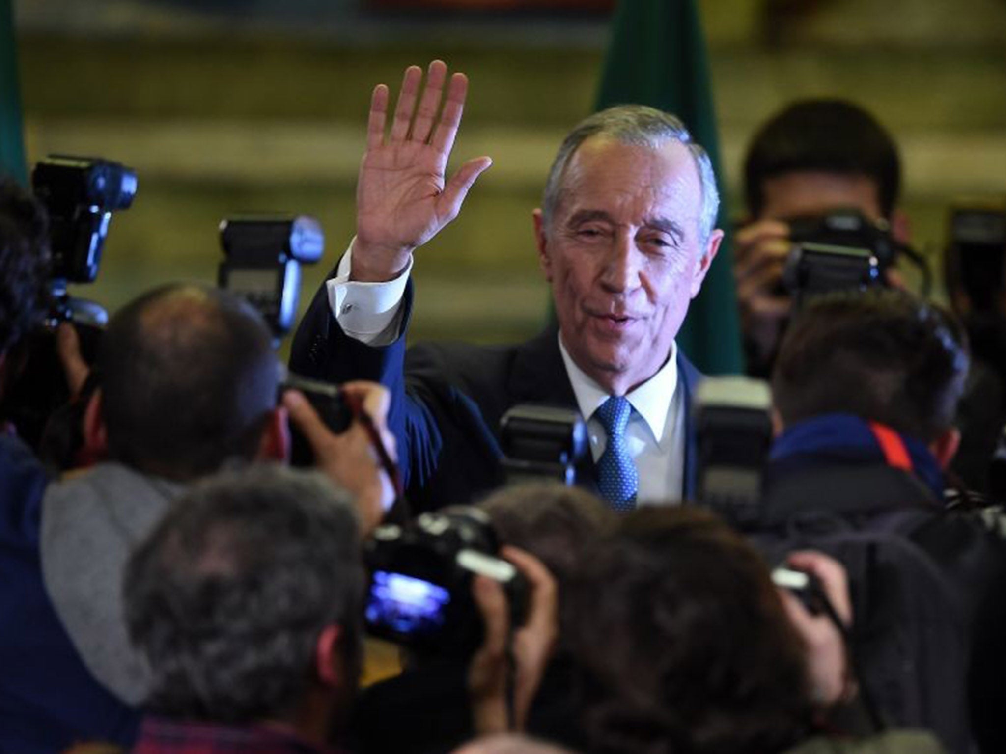 Marcelo Rebelo de Sousa greets photographers after winning the Portuguese presidential election