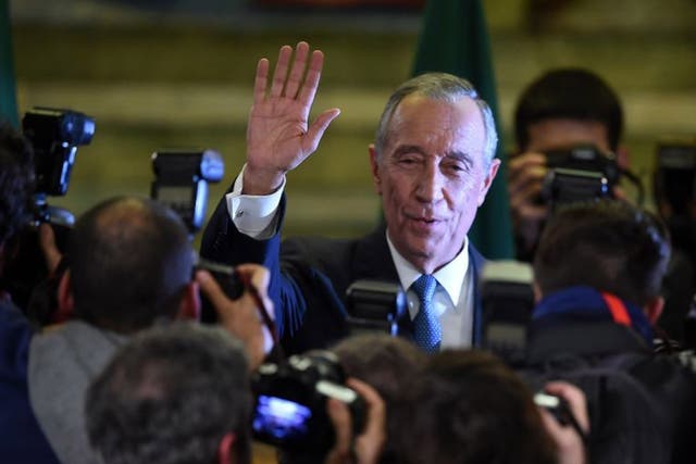 Marcelo Rebelo de Sousa greets photographers after winning the Portuguese presidential election