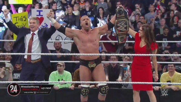 Triple H celebrates winning the Royal Rumble with Vince McMahon and Stephanie McMahon