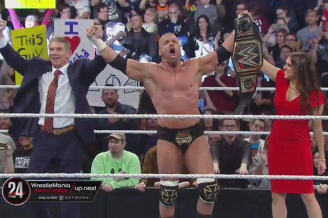 Triple H celebrates winning the Royal Rumble with Vince McMahon and Stephanie McMahon