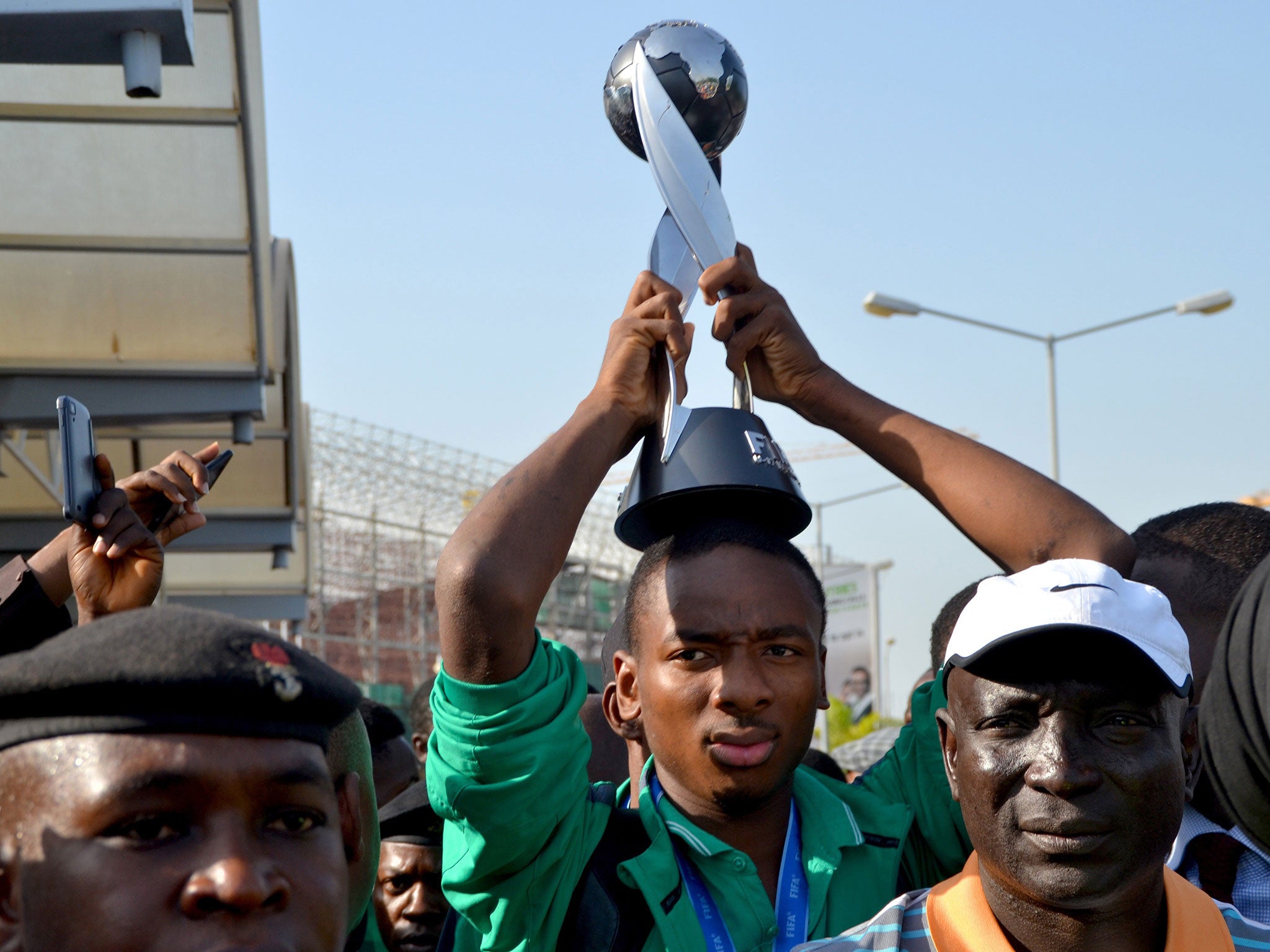 Kelechi Nwakali carries the Fifa Under-17 World Cup trophy on his head