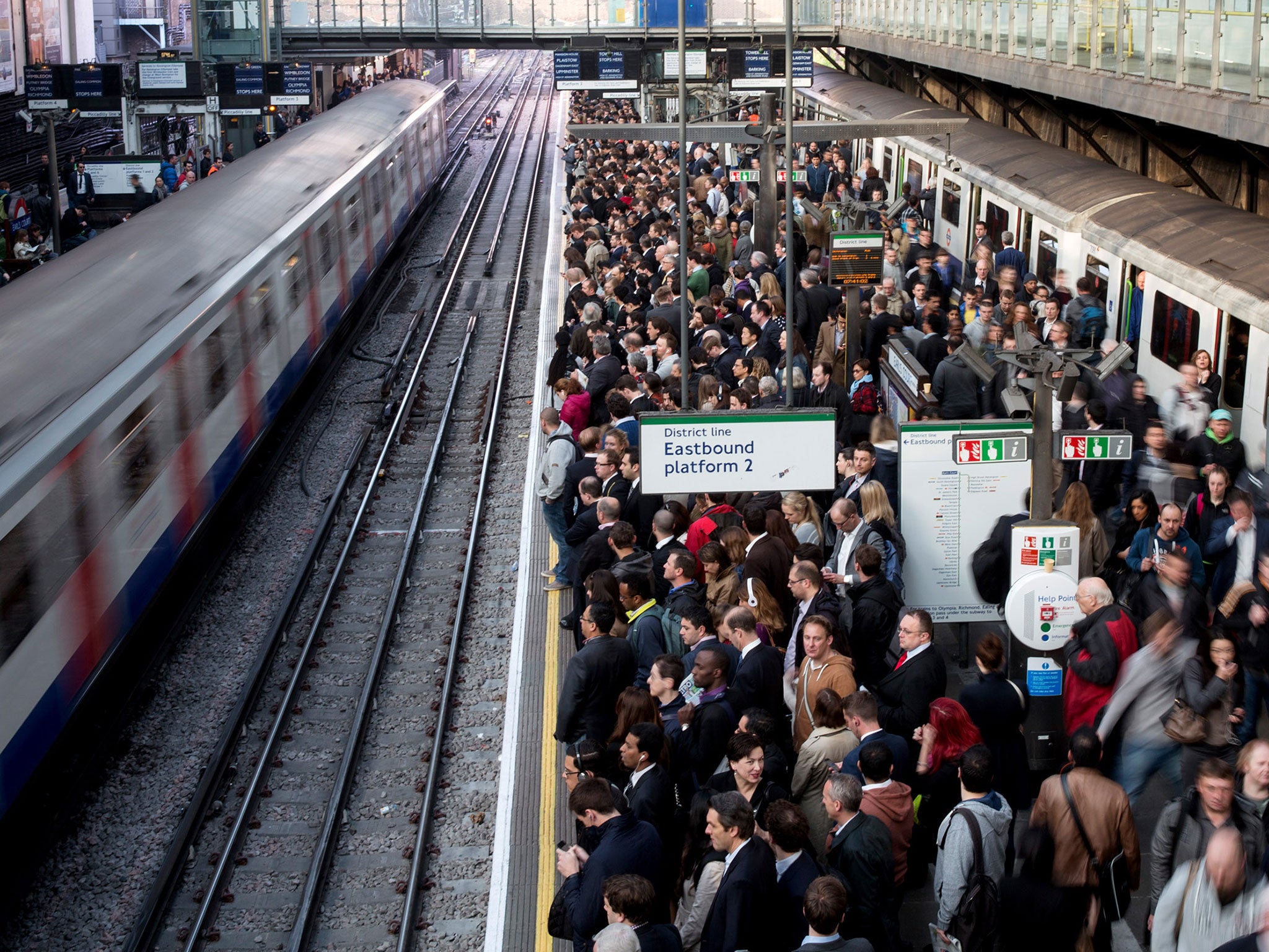 Commuters prepare to travel on the District Line of the London Underground which is running a limited service due to industrial action on 30 April, 2014 in London