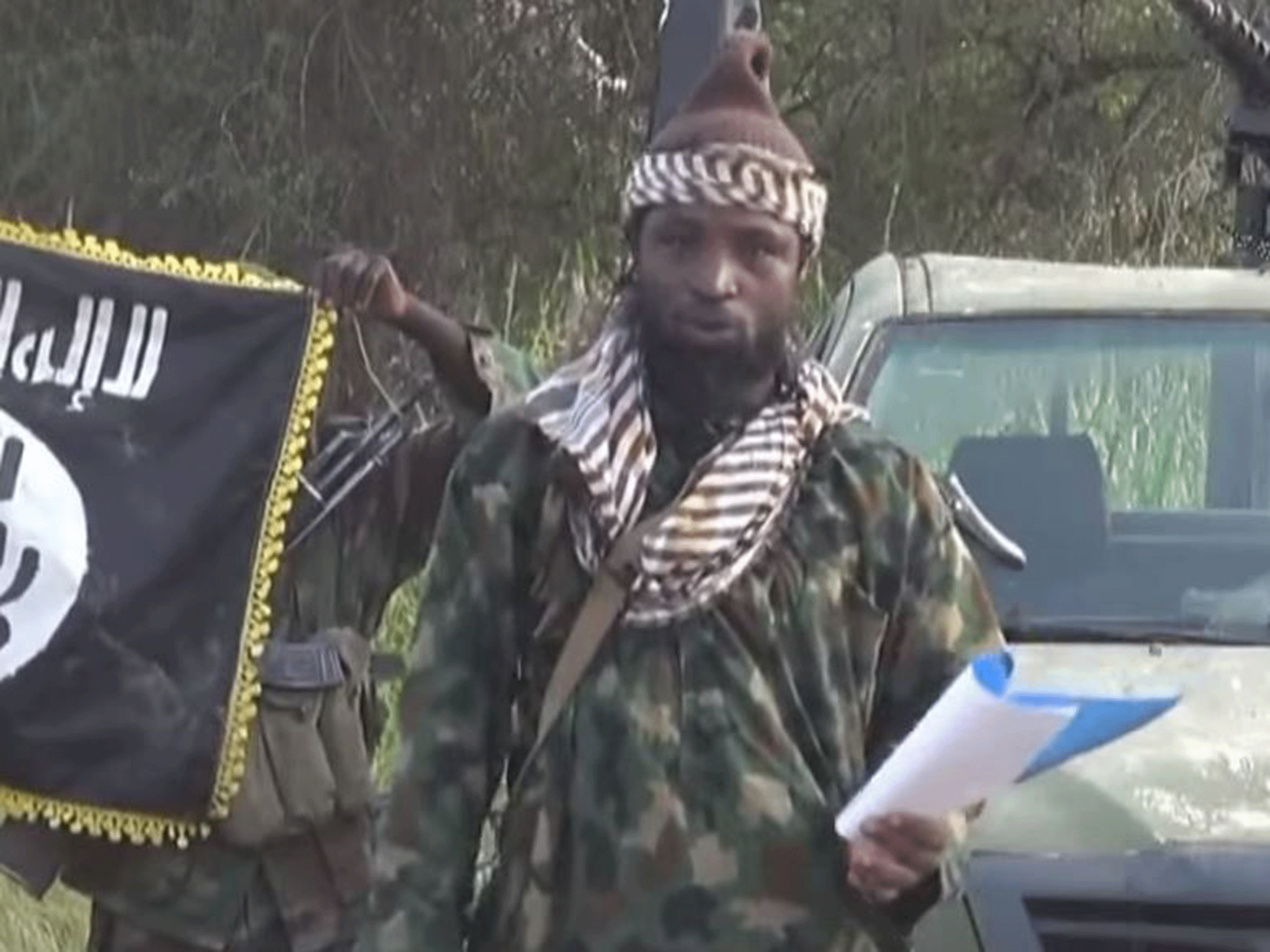 Abubakar Shekau, current leader of Boko Haram, speaking from a script to announce a "caliphate" in October 2014