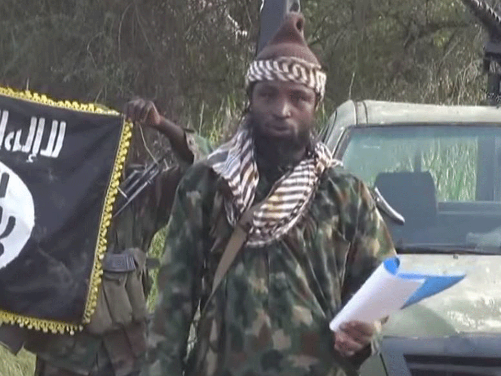 Abubakar Shekau, the former leader of Boko Haram, speaking from a script to announce a "caliphate" in October 2014