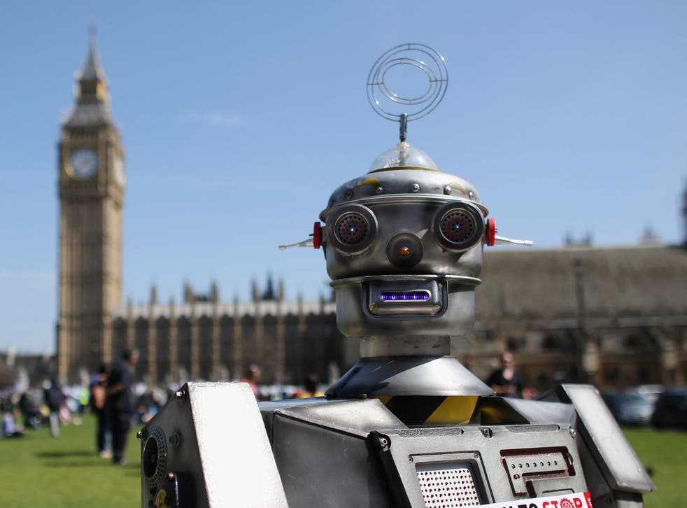 A robot owned by the Campaign to Stop Killer Robots distributes promotional literature calling for a ban on fully autonomous weapons in Parliament Square