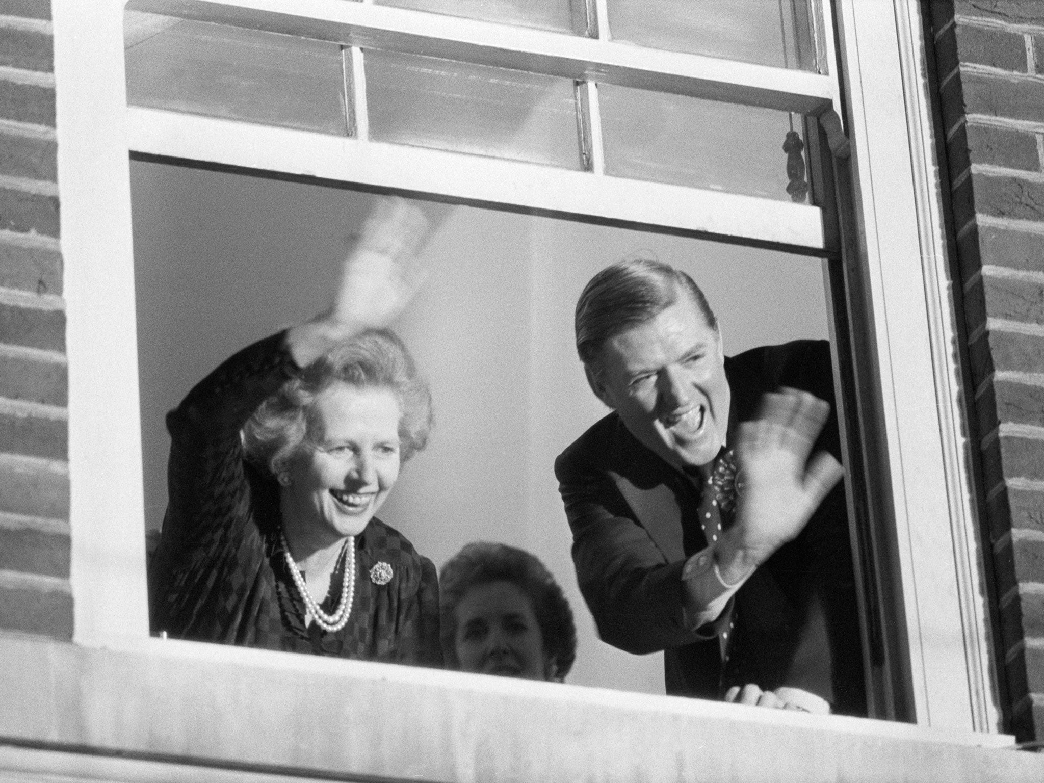 Prime Minister Margaret Thatcher and Conservative Party Chairman Cecil Parkinson wave from party headquarters after their election victory in 1983