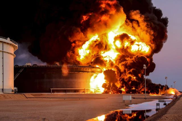 Fire rises from an oil tank in Ras Lanuf, Libya. Attacks against Libya's biggest oil terminals in recent weeks have been lethal and sustained