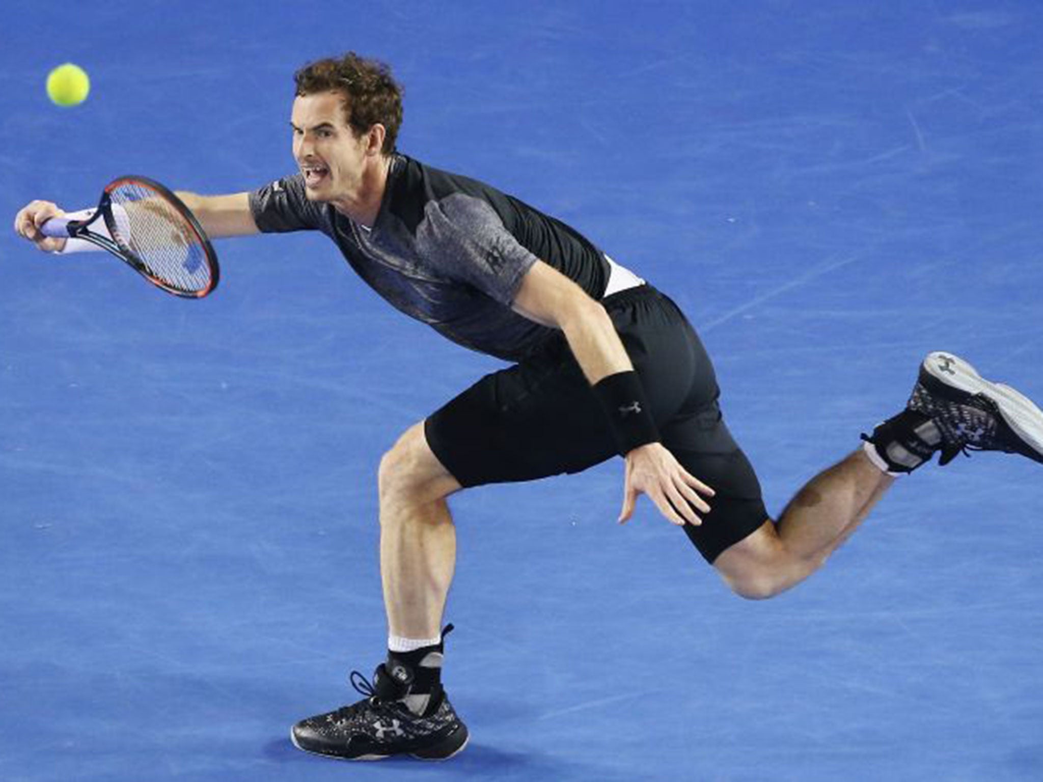 Andy Murray stretches for a forehand on his way to victory over Bernard Tomic