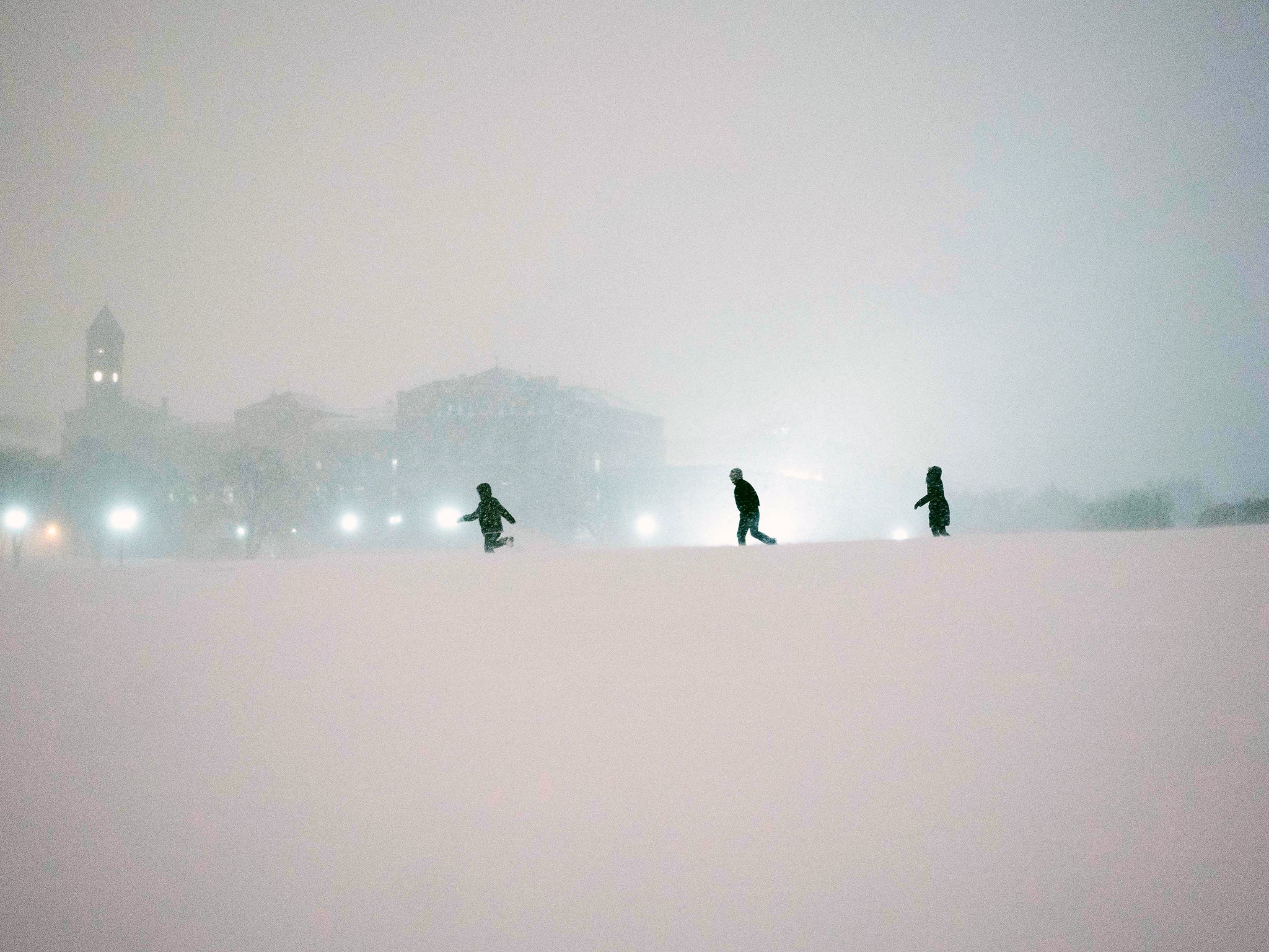 People play in the snow on the National Mall after a snowstorm in Washington. A deadly blizzard blanketed the eastern United States in near-record amounts of snow], shutting down New York and Washington in a colossal storm expected to affect more than 85 million people]