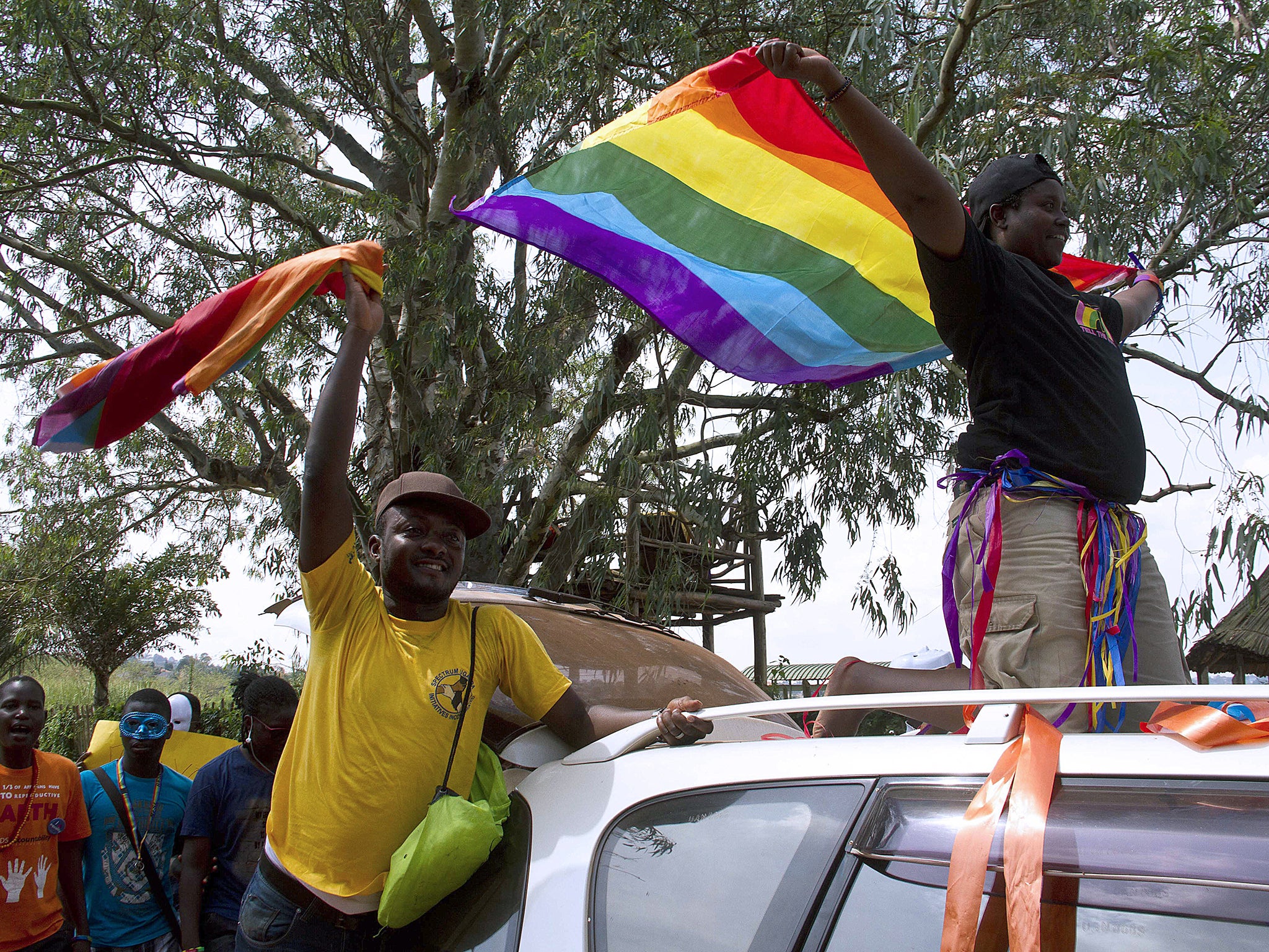 Ugandans waved rainbow flags in 2020 during the the first gay pride rally since the overturning of a tough anti-homosexuality law