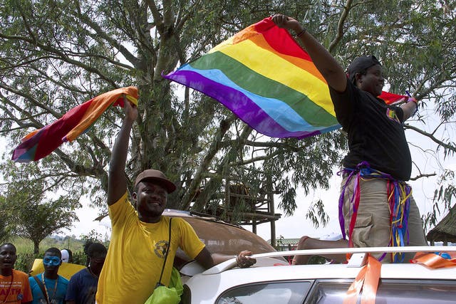 People wave rainbow flag during the the first gay pride rally since the overturning of a tough anti-homosexuality law in Entebbe, Uganda