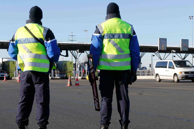 Armed French gendarmes stand next to a toll station as they check vehicles and verify the identity of travellers on the A2 motorway between Paris and Brussels