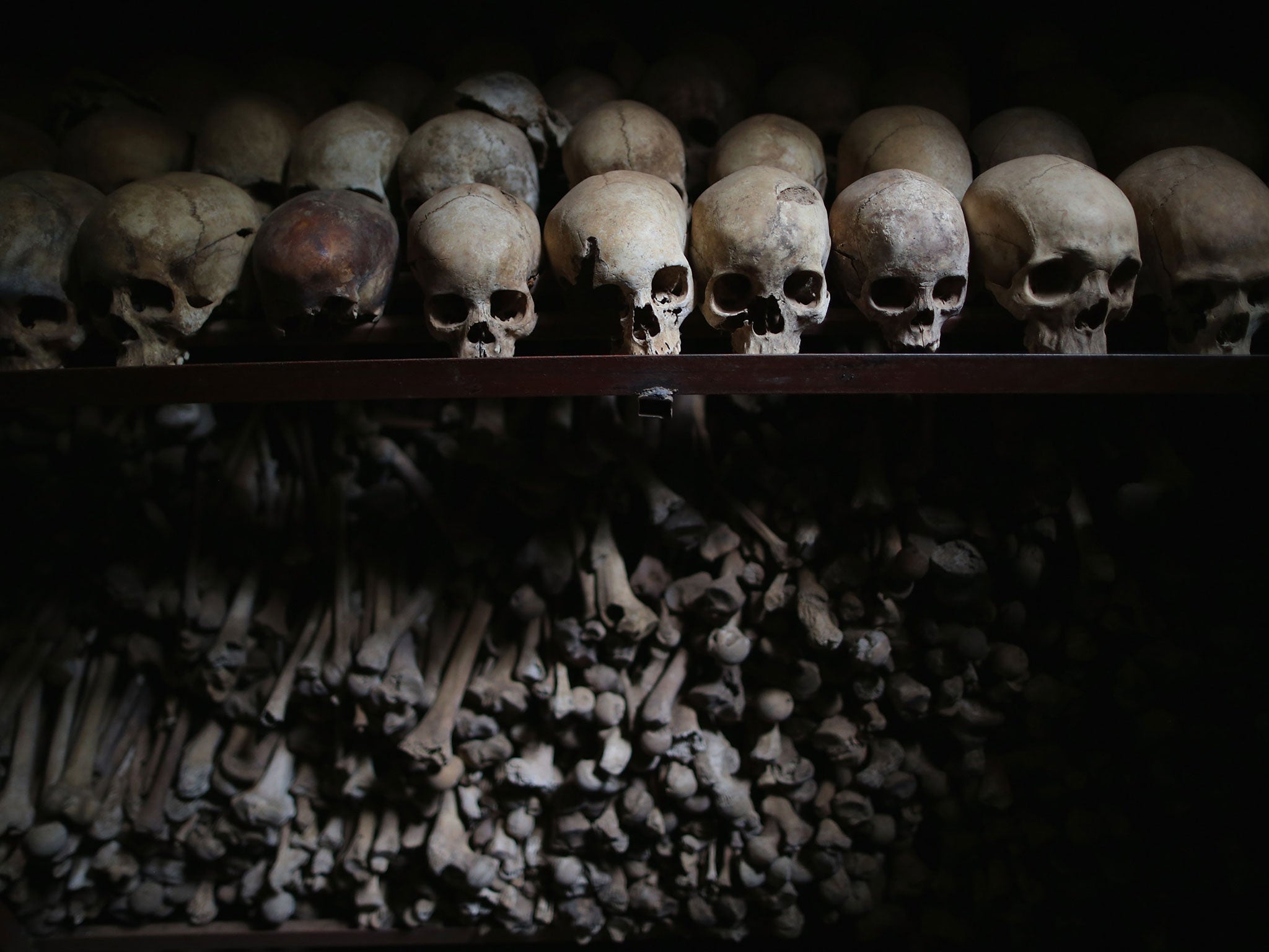 Metal racks hold the bones of thousands of Rwandan Genocide victims inside one of the crypts at the Nyamata Catholic Church