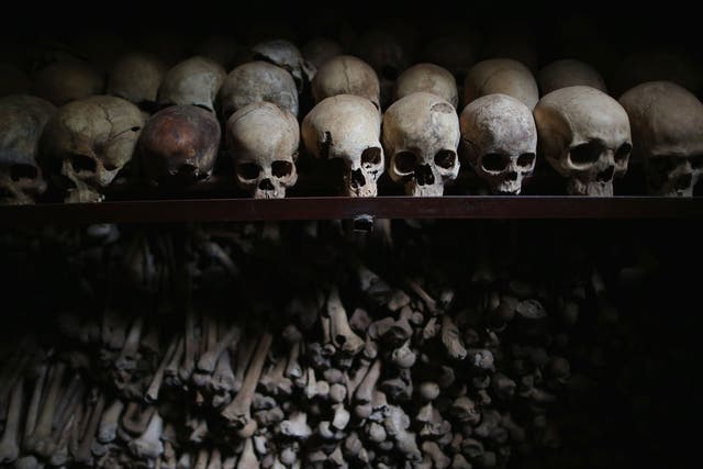 Metal racks hold the bones of thousands of Rwandan Genocide victims inside one of the crypts at the Nyamata Catholic Church