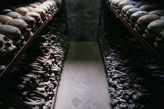 Metal racks hold the bones of thousands of Rwandan Genocide victims inside one of the crypts at the Nyamata Catholic Church memorial