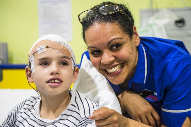 Melissa Strickland with 11-year-old Henry Green on Koala Ward, which deals with brain-related surgery