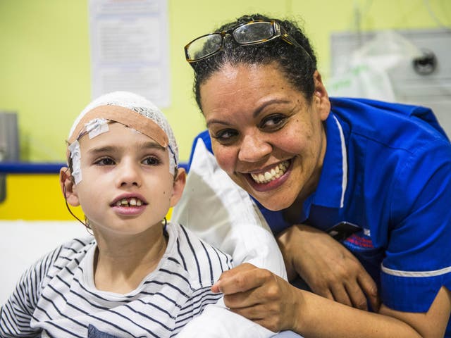 Melissa Strickland with 11-year-old Henry Green on Koala Ward, which deals with brain-related surgery