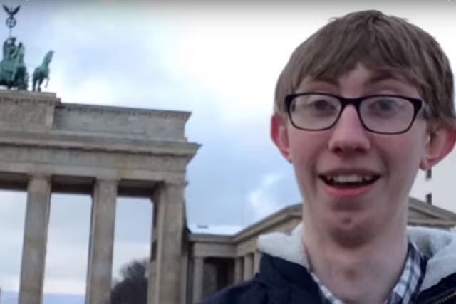 Jordan Cox outside the Brandenburg Gate in Berlin as he details how he saved money on his adventure
