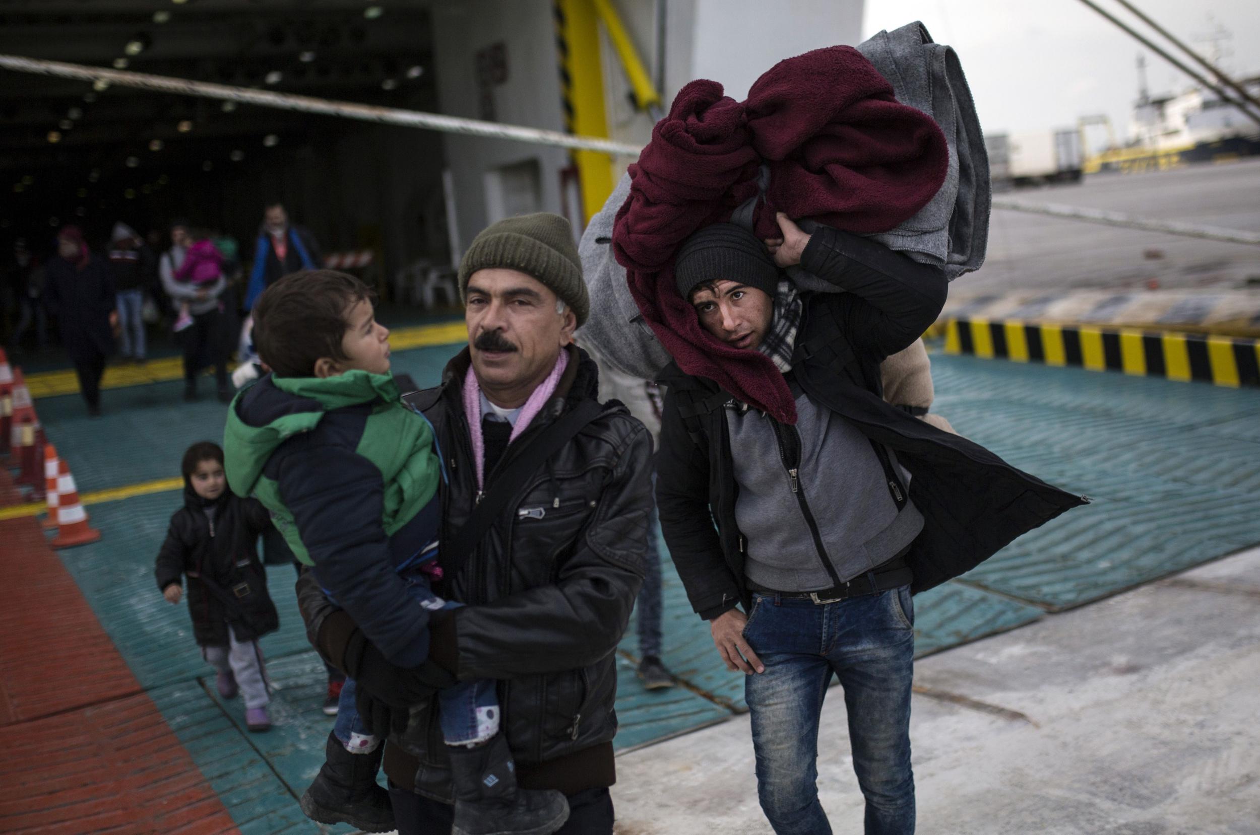 Refugees arrive on a port near Athens earlier this year