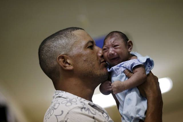 Geovane Silva holds his son Gustavo Henrique, who has microcephaly, at the Oswaldo Cruz Hospital in Recife, Brazil