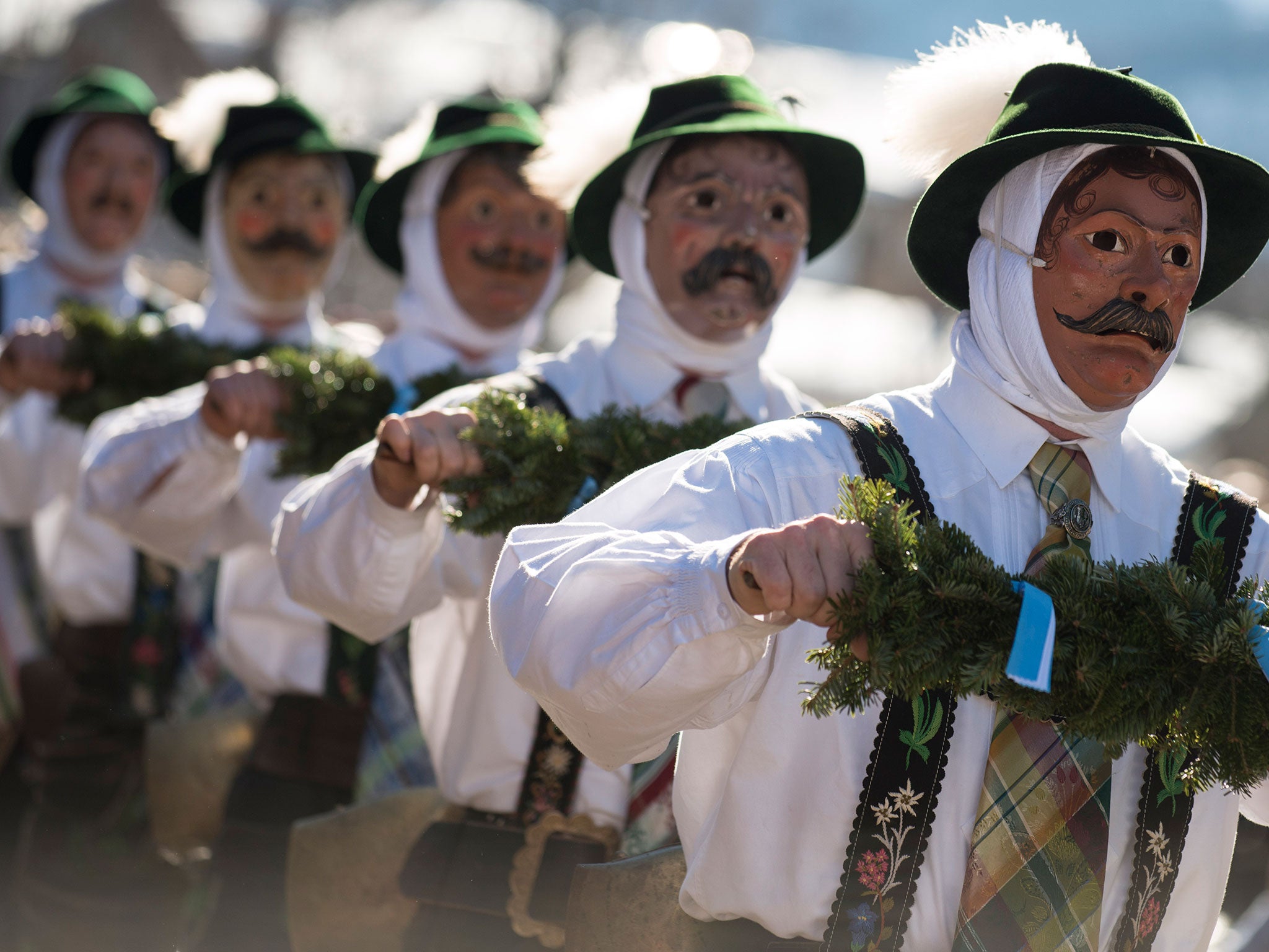 Costumed participants wearing traditional wooden masks perform in the annual carnival parade on February 12, 2015 in Mittenwald