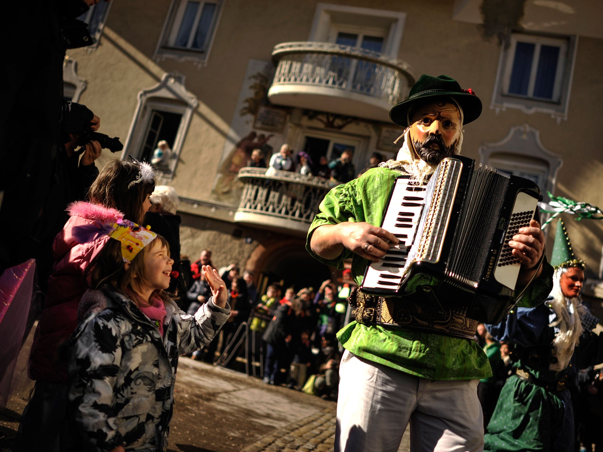 &#13;
'Fasching' in Austria and Germany sees participants wear costumes and wooden masks for parades and performances&#13;