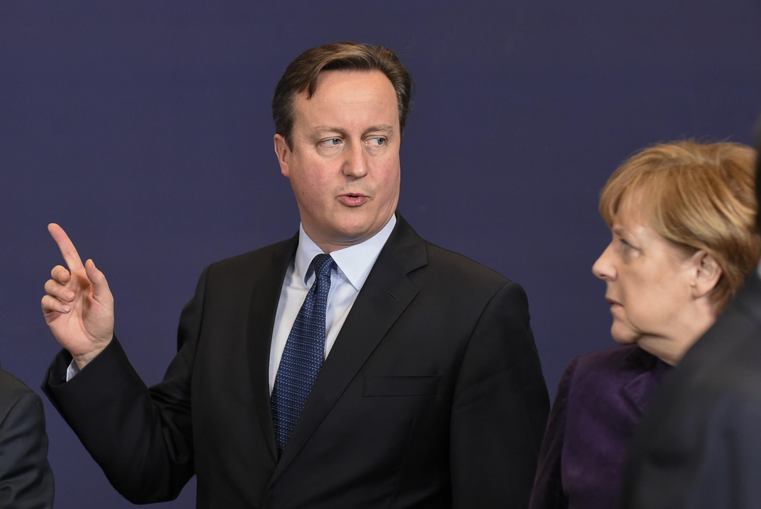 David Cameron flanked by German Chancellor Angela Merkel at the European Union (EU) summit of the year at the European Council in Brussels in December 2015