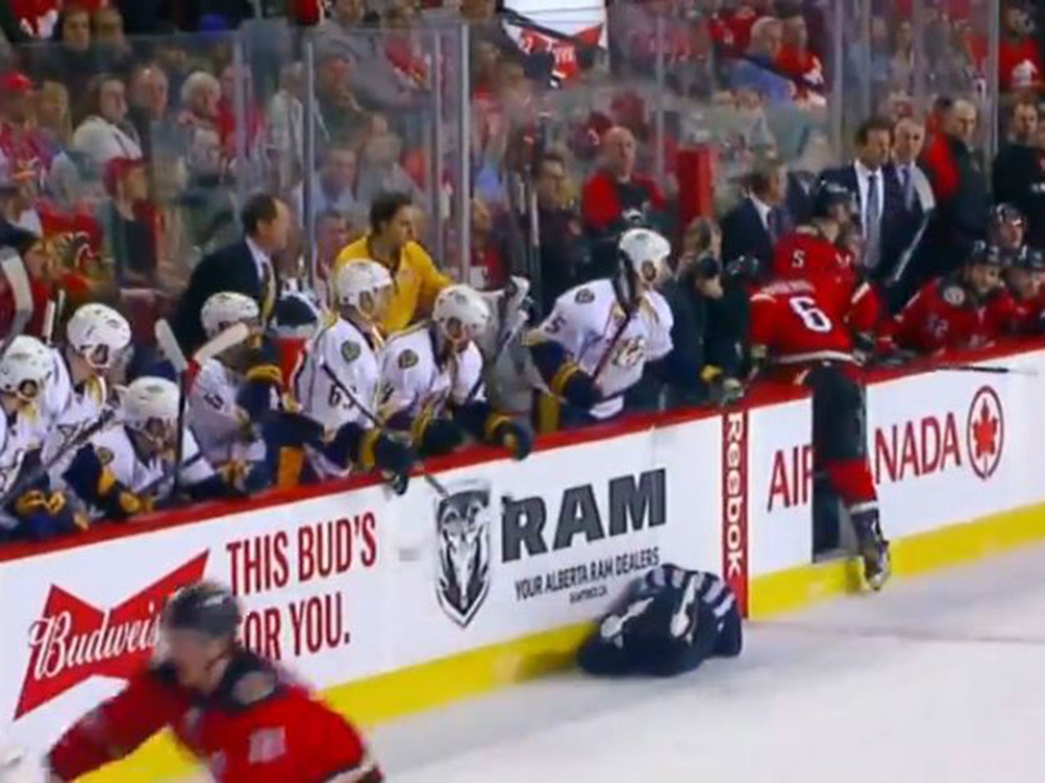 Henderson is left in a heap on the ice as Wideman makes his way to the bench