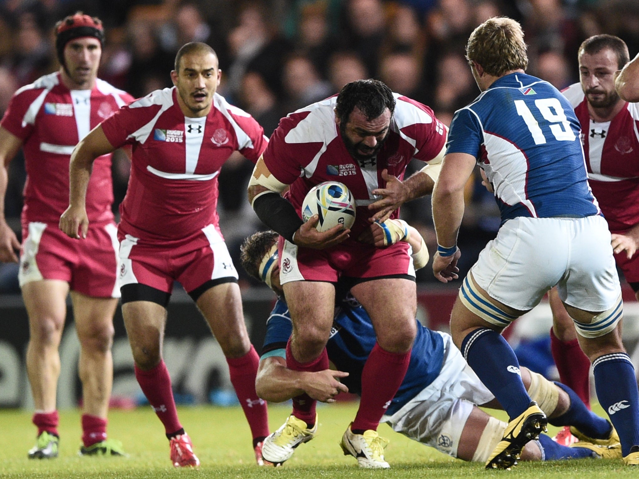 Georgia's prop Davit Zirakashvili (C) is tackled during a Pool C match of the 2015 Rugby World Cup between Namibia and Georgia