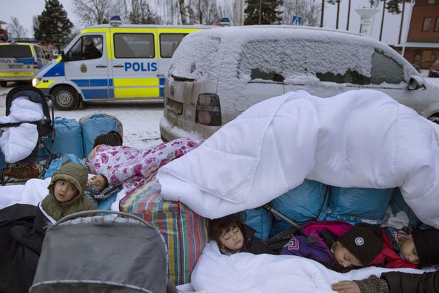 Migrant children sleep on the Swedish border. Sweden has taken in, by population, more refugees than any other EU country