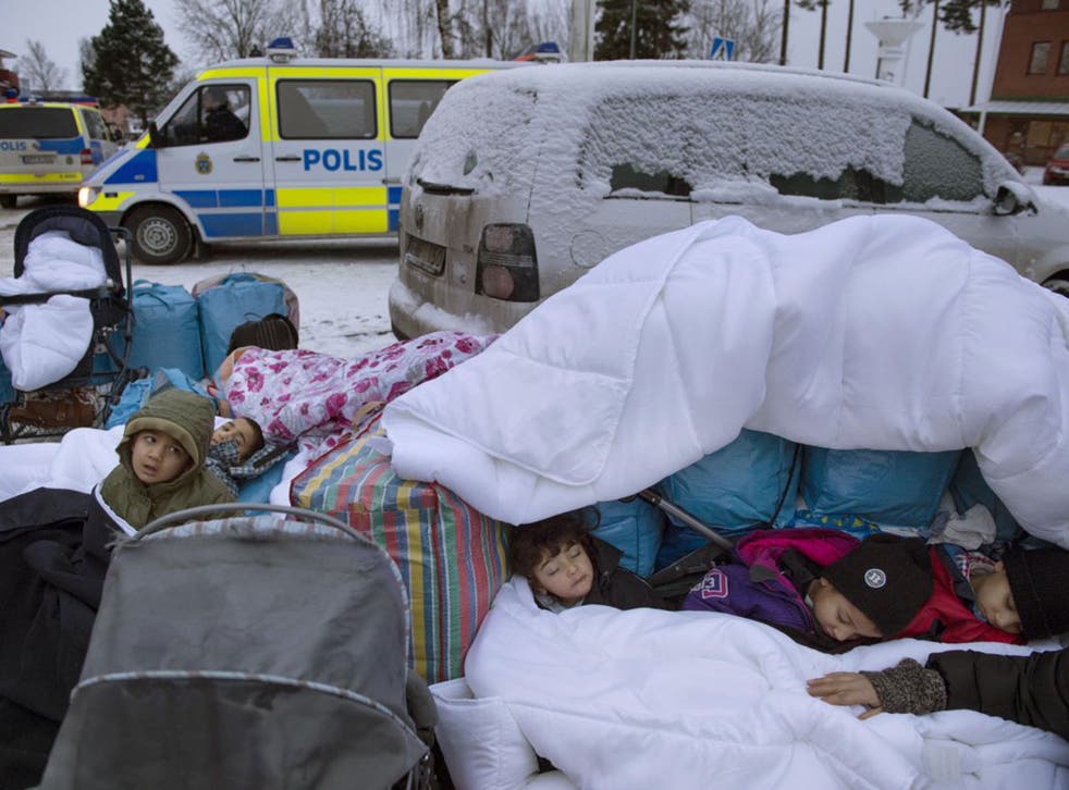 Migrant children sleep on the Swedish border. Sweden has taken in, by population, more refugees than any other EU country