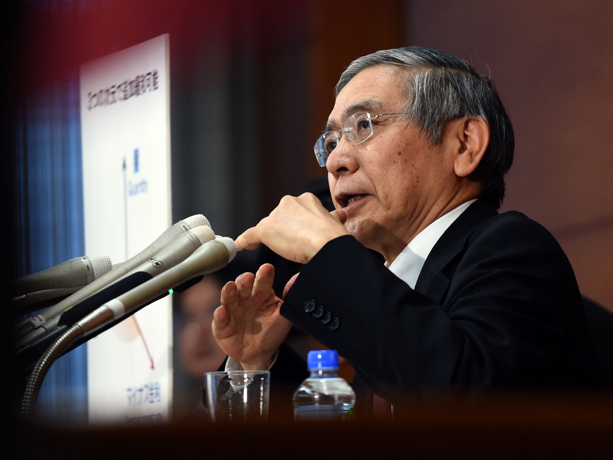 Governor of the Bank of Japan (BoJ) Haruhiko Kuroda answers a question during his regular press conference in Tokyo on January 29, 2016. The BoJ shocked markets on January 29 after it unveiled plans to effectively charge lenders to park their cash with it, ramping up its long-running battle to kickstart the world's number three economy.