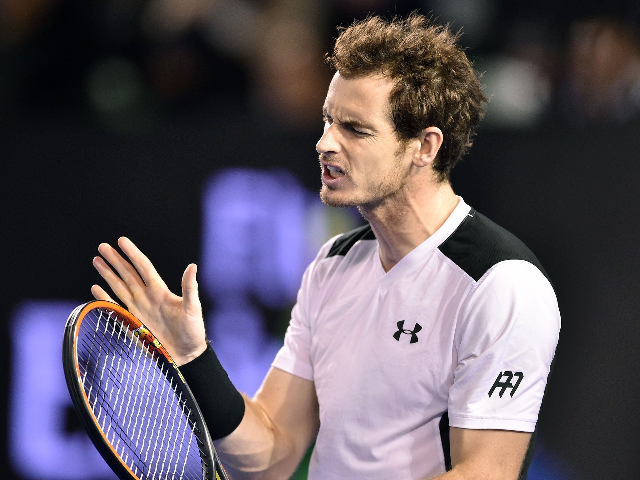Andy Murray hits his racket after losing the third set to Milos Raonic