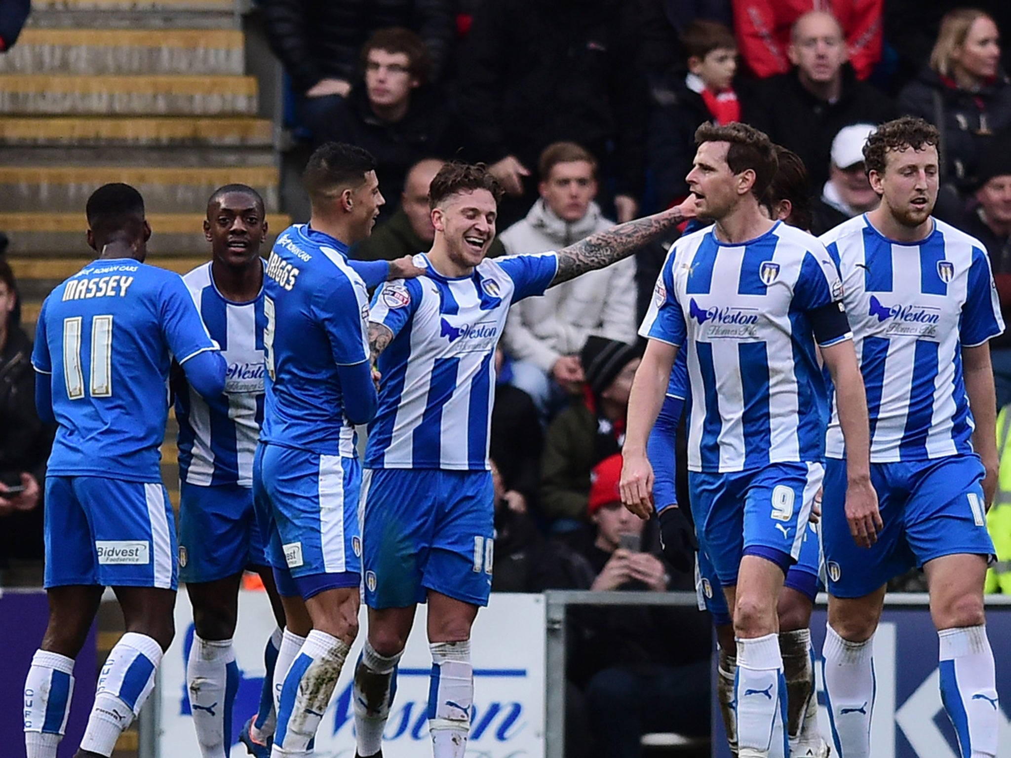 Colchester United's players celebrate going ahead against Charlton Athletic in the last round