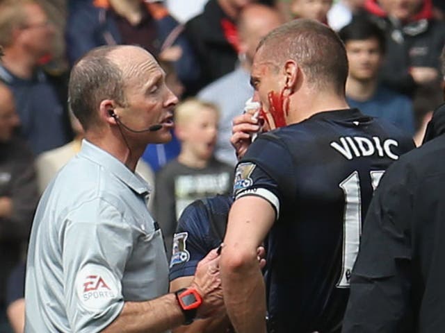 A bloody Nemanja Vidic is ordered off the field in his final Manchester United game
