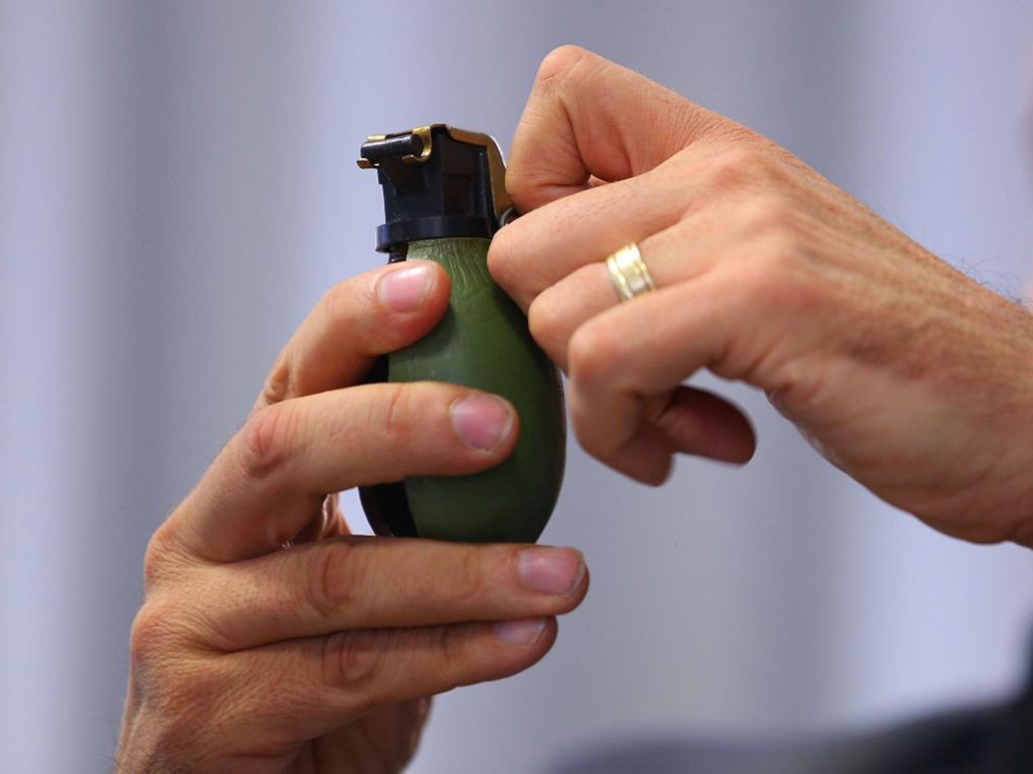 Andreas Stenger, of State Office of Criminal Investigation shows a model hand grenade after an attack on a refugee shelter January 29, 2016 in Villingen-Schwenningen, Germany.
