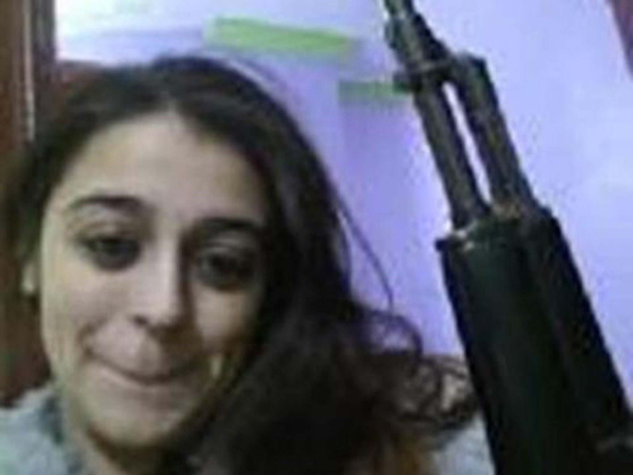 A deleted picture on Shakil's phone showing her with an AK 47