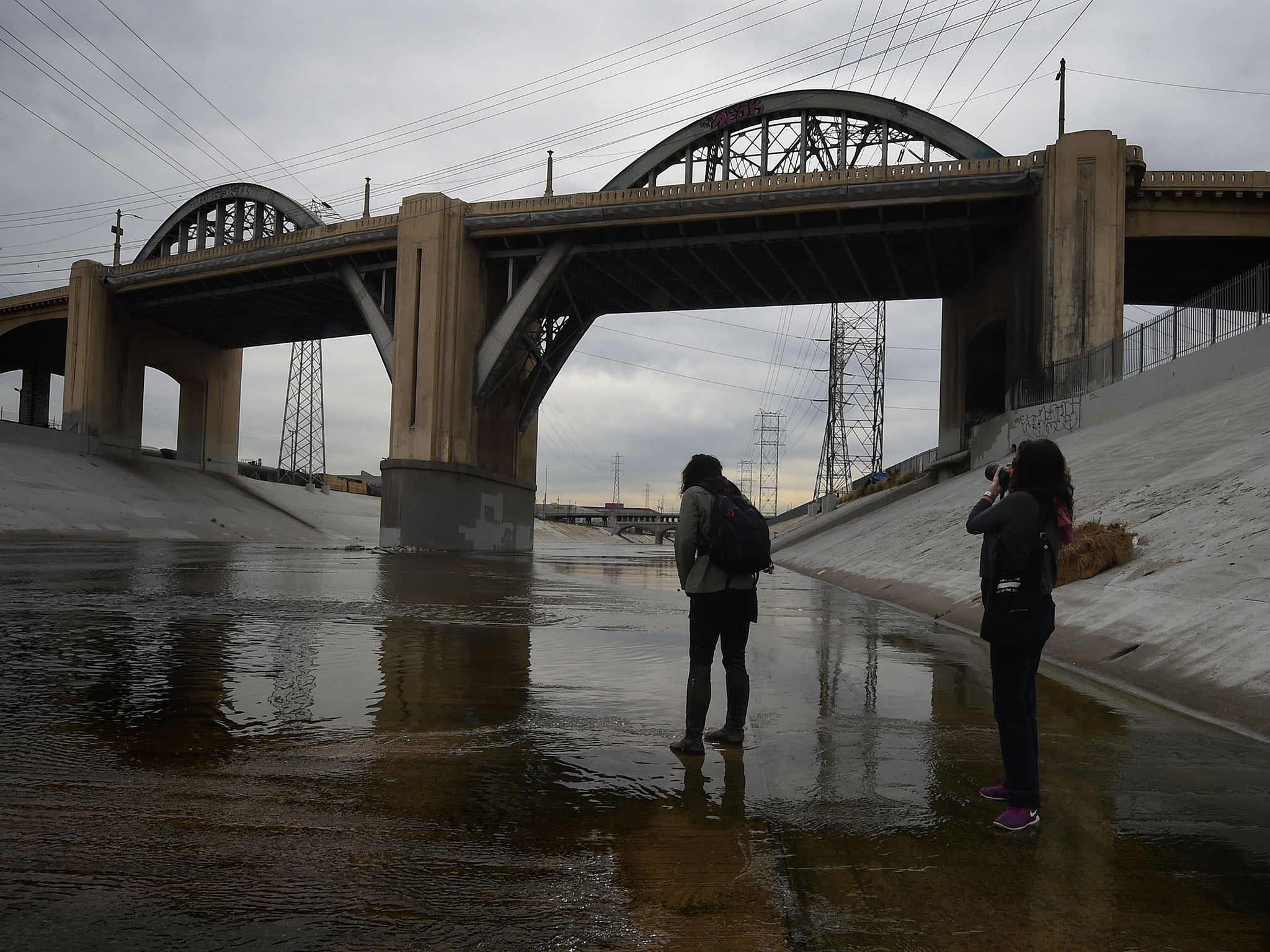 People take photographs as they come to say goodbye to the iconic 6th Street Bridge that connects downtown Los Angeles with its eastern disticts
