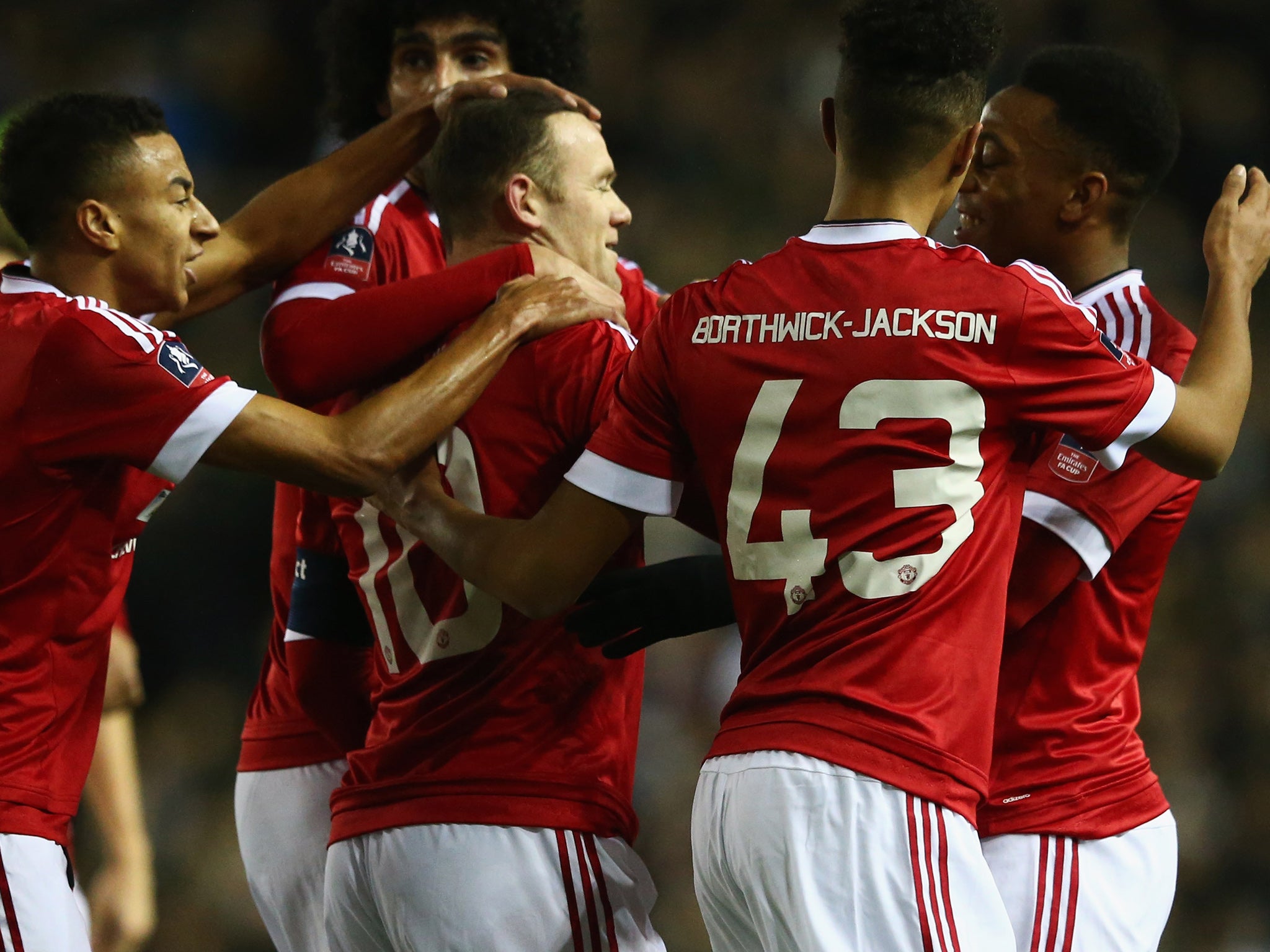 Wayne Rooney is mobbed by team-mates after opening the scoring