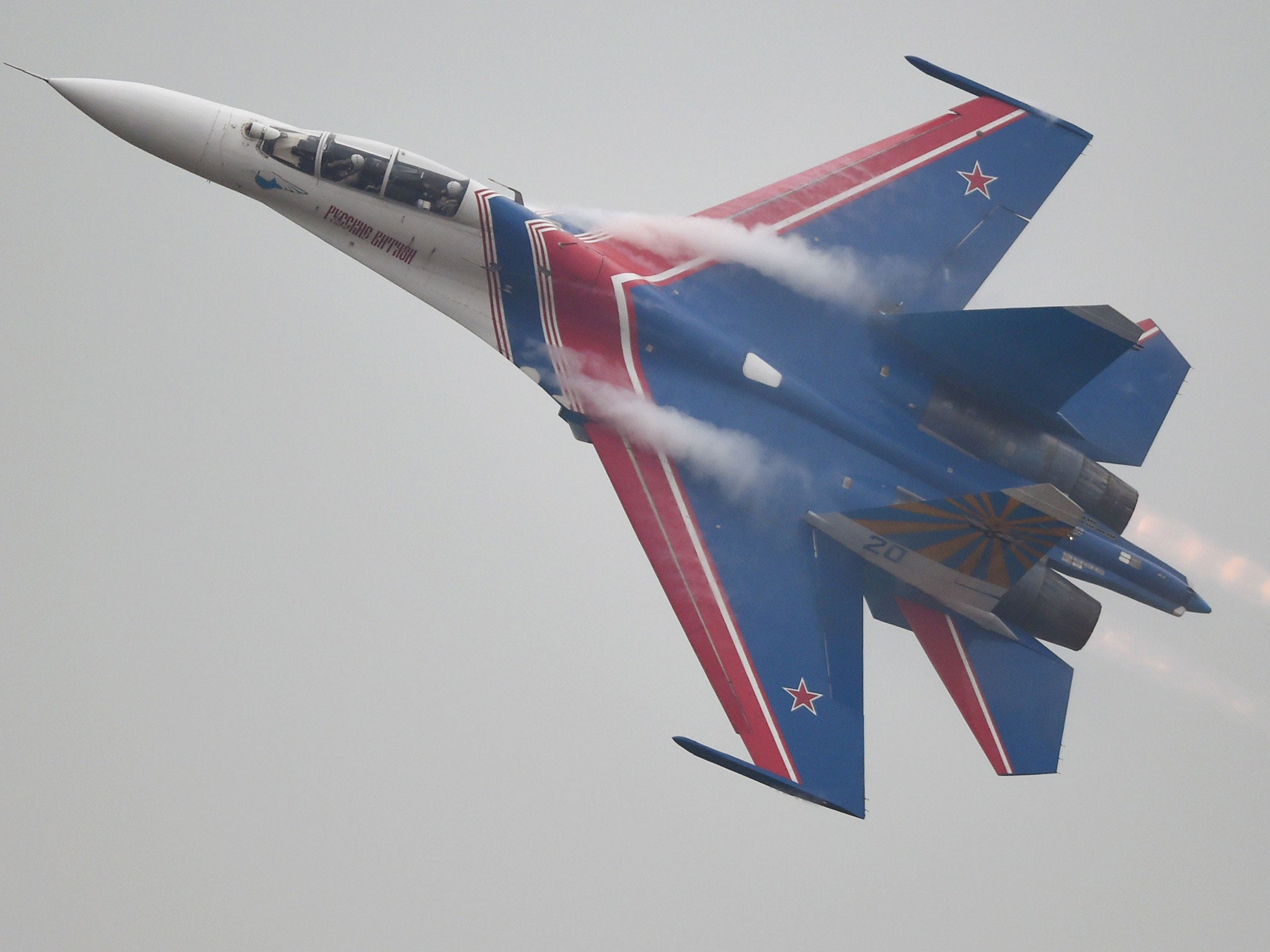 The Russian Airforce 'Knigths' Aerobatic Team performs in their Su-27 jets during a test flight ahead of the Airshow China 2014 in Zhuhai, south China's Guangdong province on 10 November, 2014