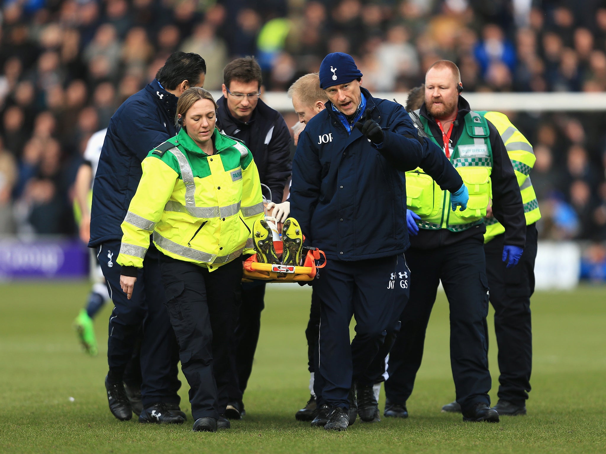 Colchester United's Alex Wynter is stretchered off the field